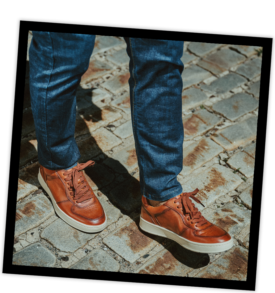 A man wearing the Venton Sneaker in Cognac (tan).