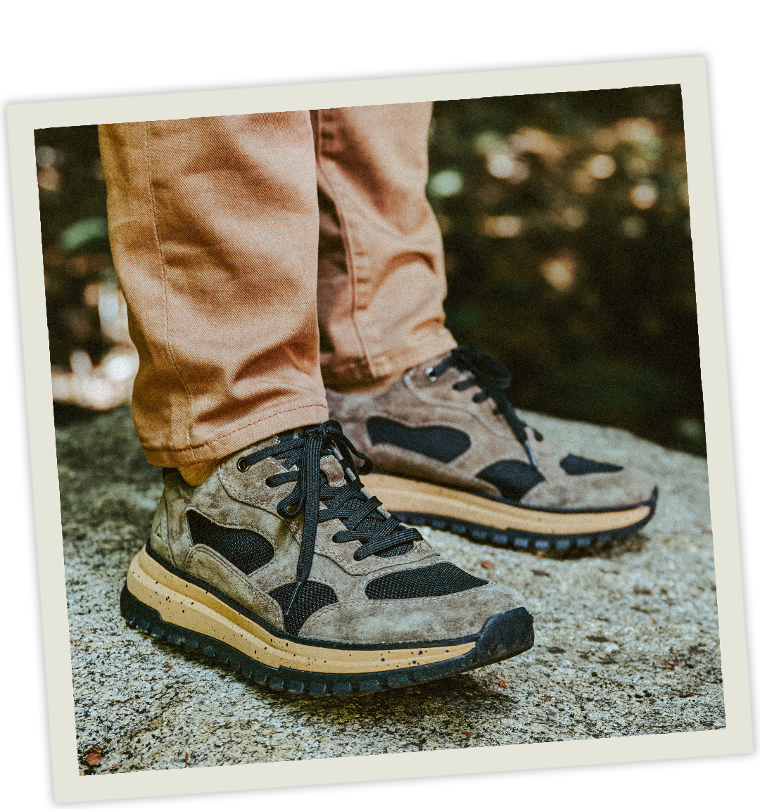 A man wearing the Breck sneaker in grey.