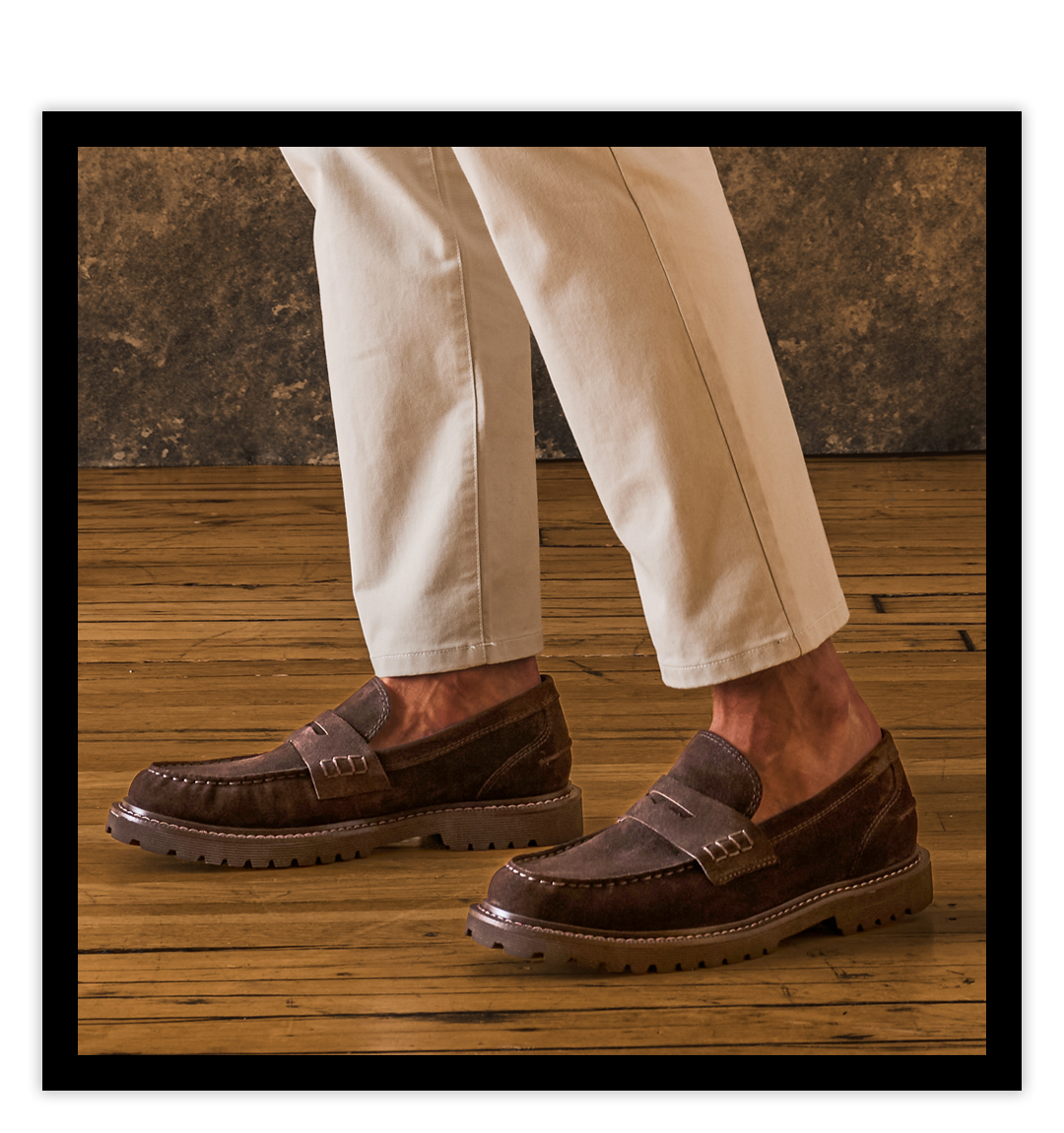 A Man wearing the Waylon Leather Penny Loafers in Lince Dark Brown.