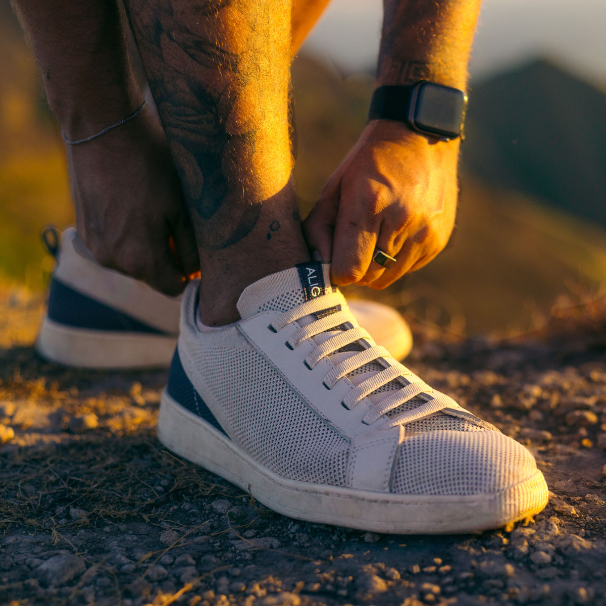 A man wearing the Donovan sneakers in Off White. Shop Donovan.