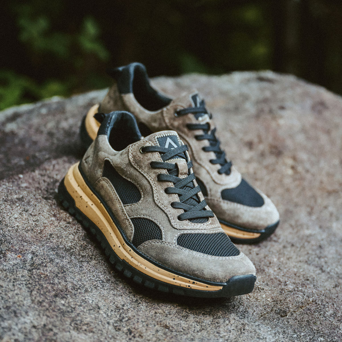 Breck Lace Up Sneakers in Dark Taupe on a rock. Shop Breck.