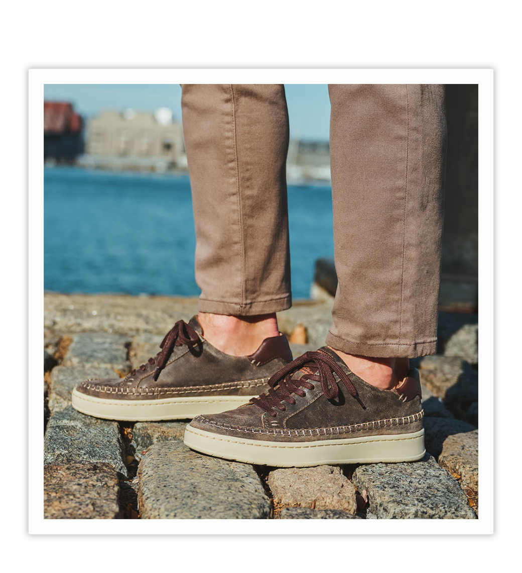 Man wearing the Voyage sneaker in brown.
