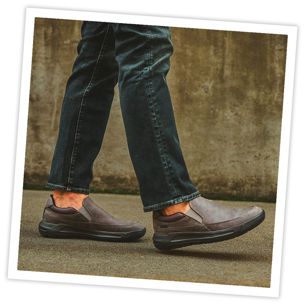 Man wearing the Elliott slip on shoe in grey.